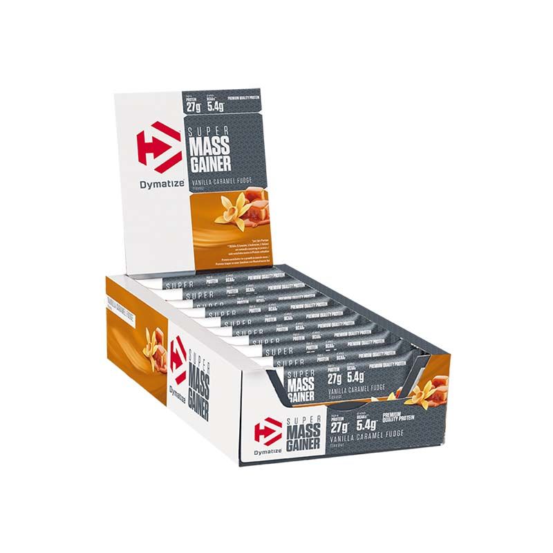 The Mass Gainer Bar Dymatize display box. Bars are visible. The box has the brand logo and product name. Vanilla Caramel Fudge flavor is indicated.
