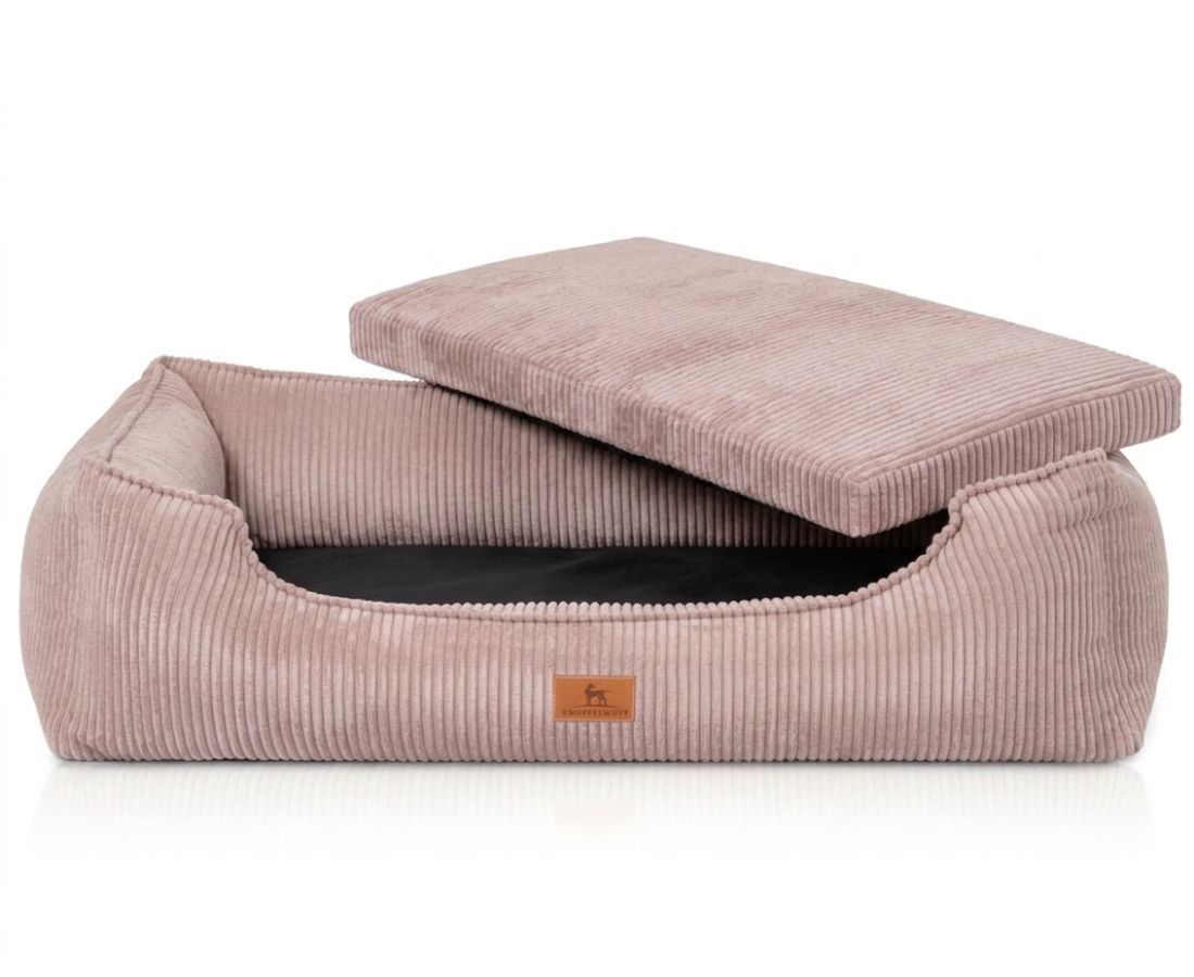 Rosa Cord-Hundebett mit abnehmbarem Kissen und schwarzer Innenseite.