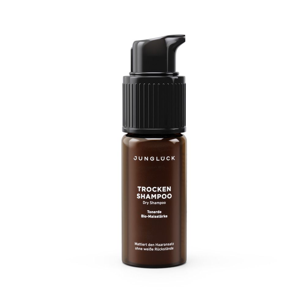 Braune Flasche mit schwarzem Pumpkopf. Beschriftung: JUNGLÜCK, Trocken Shampoo, Towards Bio-Maisstärke.