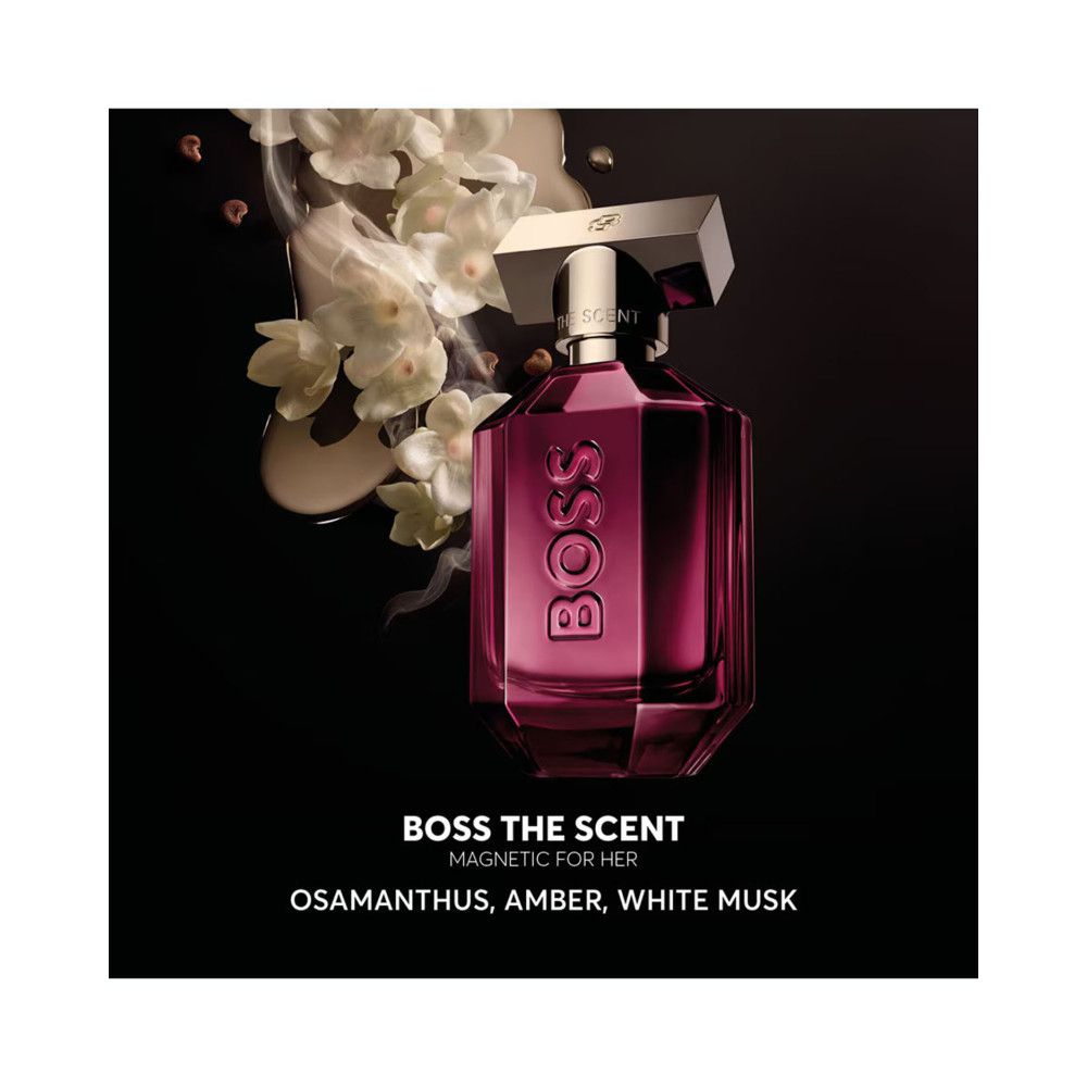 BOSS The Scent Magnetic EDP Flakon. Pink, eckig, goldener Verschluss. Schriftzug BOSS. Blüten und Nebel im Hintergrund.