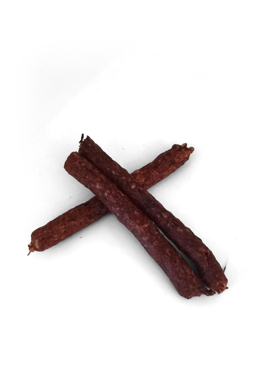 Drei getrocknete Fleischsticks, dunkelbraun, auf weißem Hintergrund. Die Sticks sind länglich und unregelmäßig geformt.