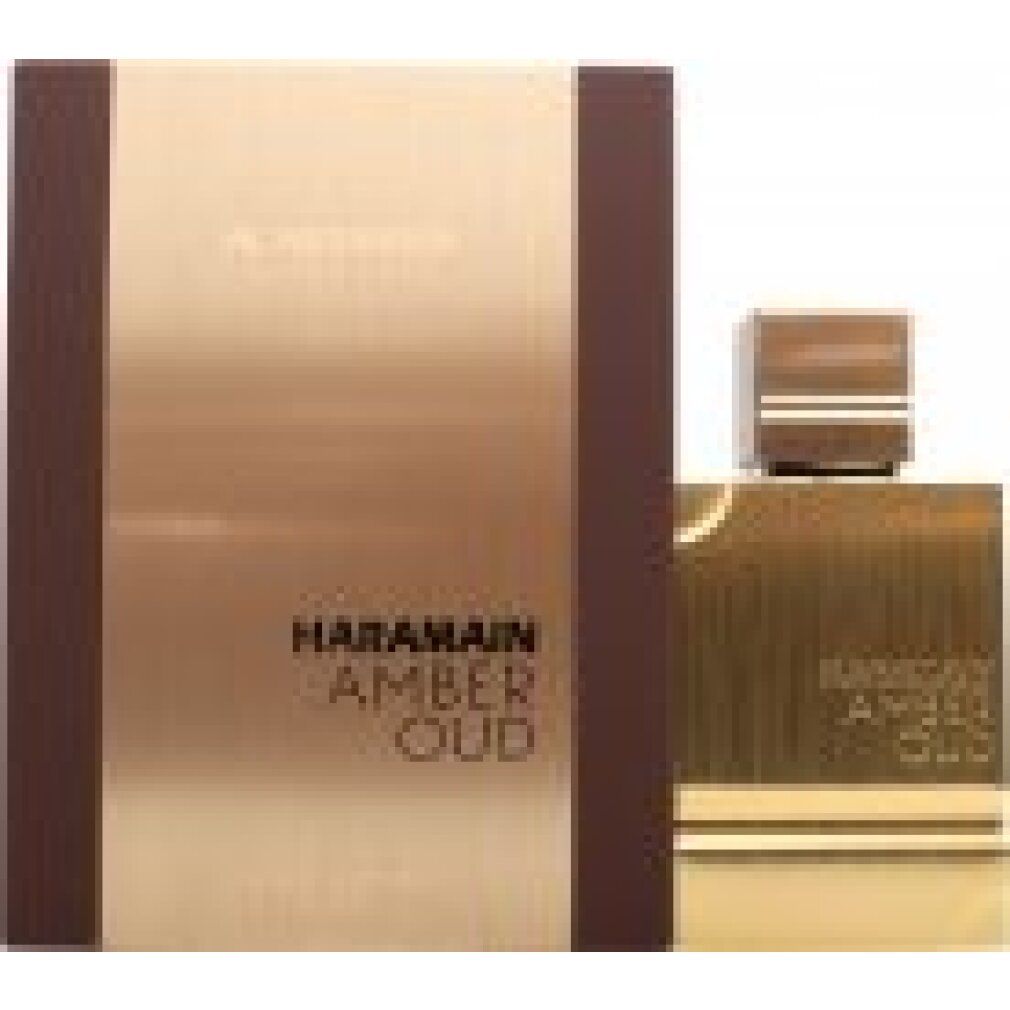 Goldfarbener Flakon und Verpackung. Aufschrift: HARAMAIN AMBER OUD. Braune Verpackung mit goldfarbener Front. Flakon mit goldfarbenem Deckel.