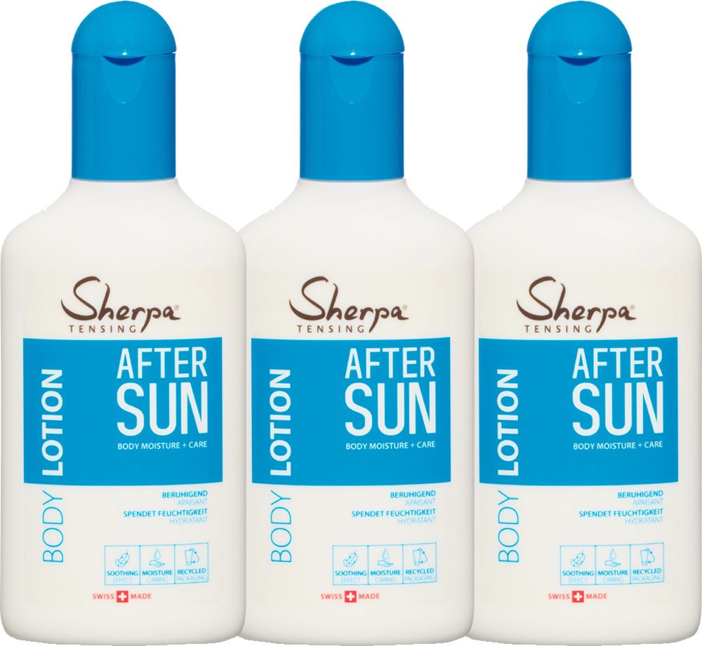 Drei weiße Flaschen mit blauem Deckel. Aufschrift: Sherpa Tensing After Sun Body Lotion. Schweizer Kreuz.
