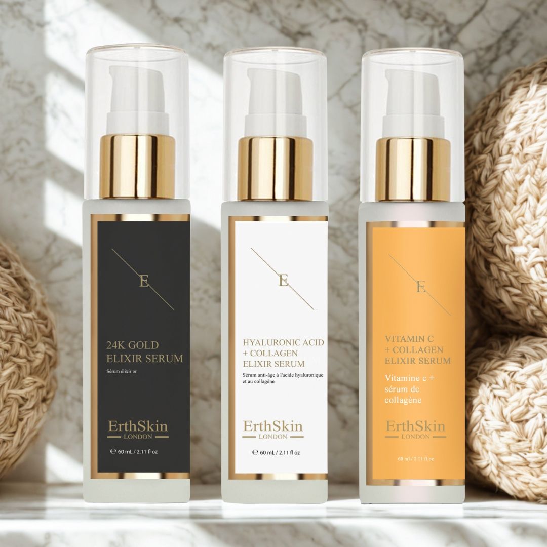 Drei Serumflaschen mit goldenen Deckeln und Etiketten. Beschriftung: 24K Gold, Hyaluronsäure + Kollagen, Vitamin C + Kollagen. Marke: ErthSkin London.