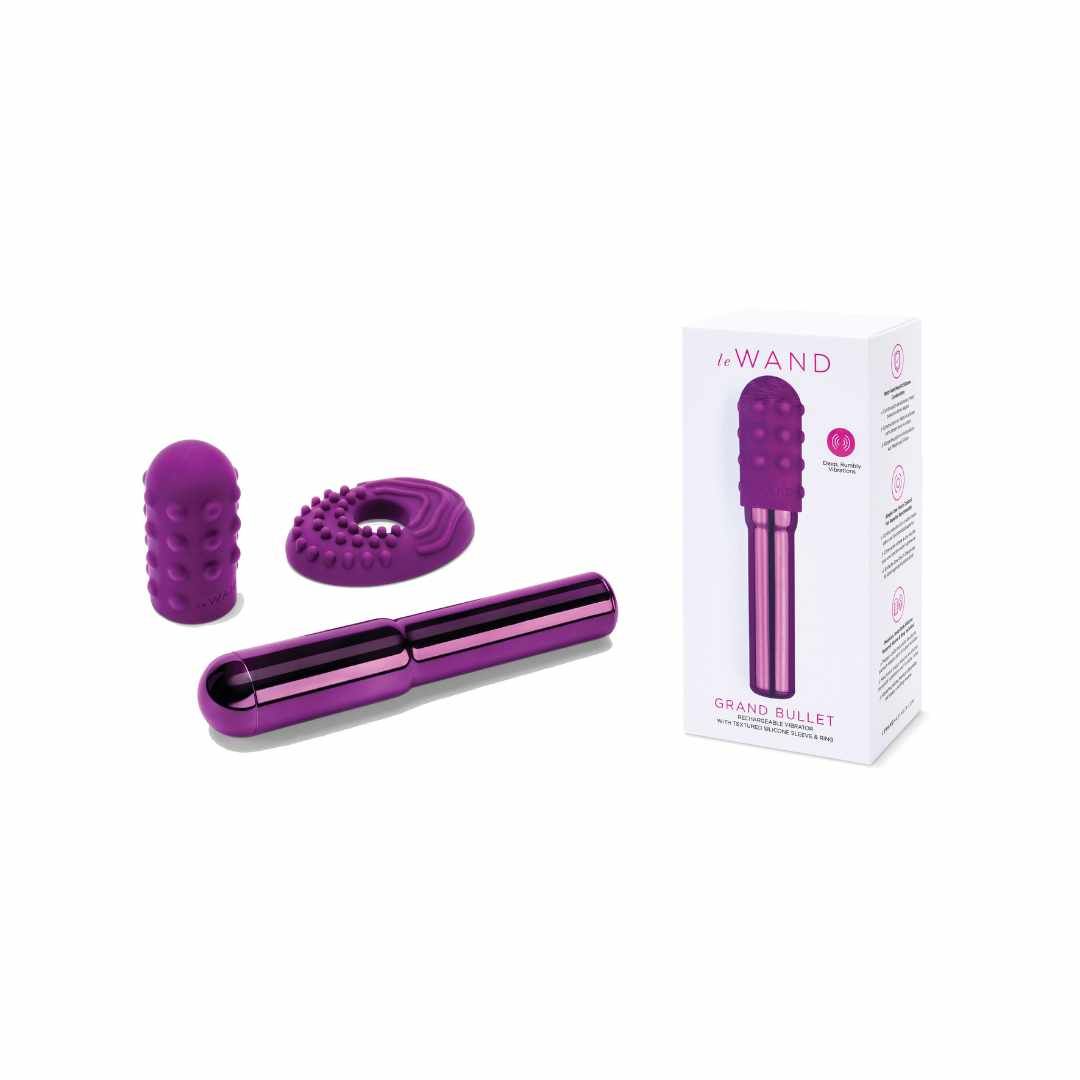 Produktverpackung mit Vibrator und Zubehör. Weißer Karton mit Produktabbildung und Text. Lila Vibrator.