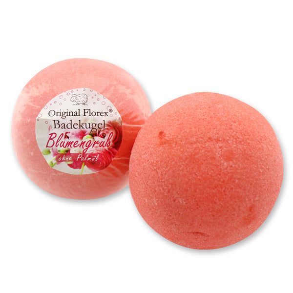 Zwei rote Badekugeln. Eine in Folie verpackt, mit Aufschrift: Original Florex Badekugel, Blumengruß.