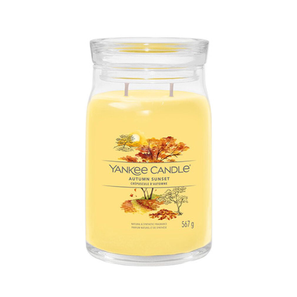 Duftkerze mit Deckel. Gelbes Wachs in Glasbehälter. Aufschrift: Yankee Candle Autumn Sunset. Gewicht: 567 g.