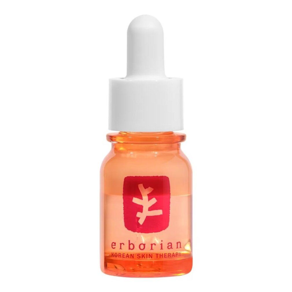 Orangefarbene Glasflasche mit Pipettenverschluss, Etikett mit Text und Symbolen.