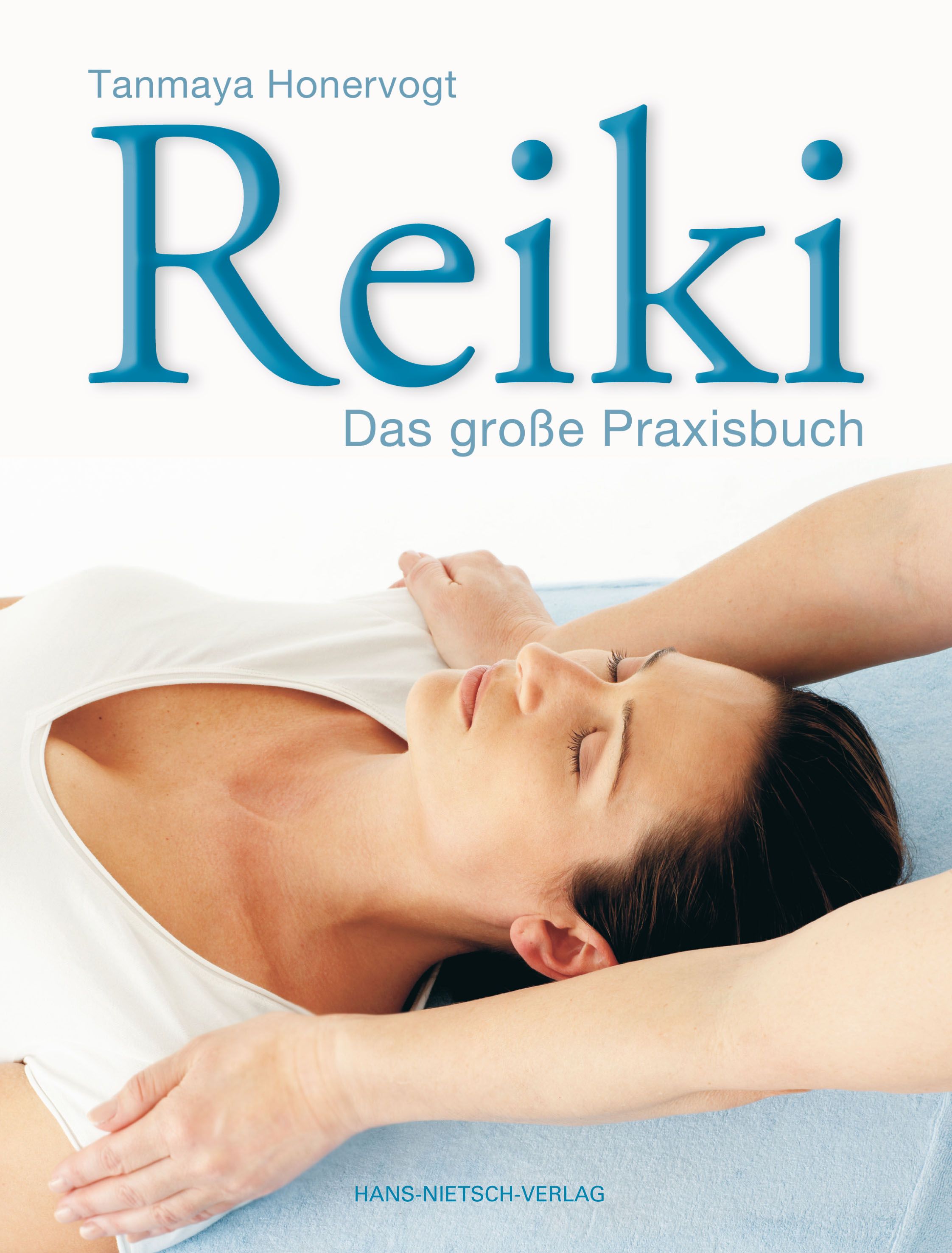 Buchcover mit Titel "Reiki" und Autor. Frau liegt, Hände auf ihr. Verlag unten.