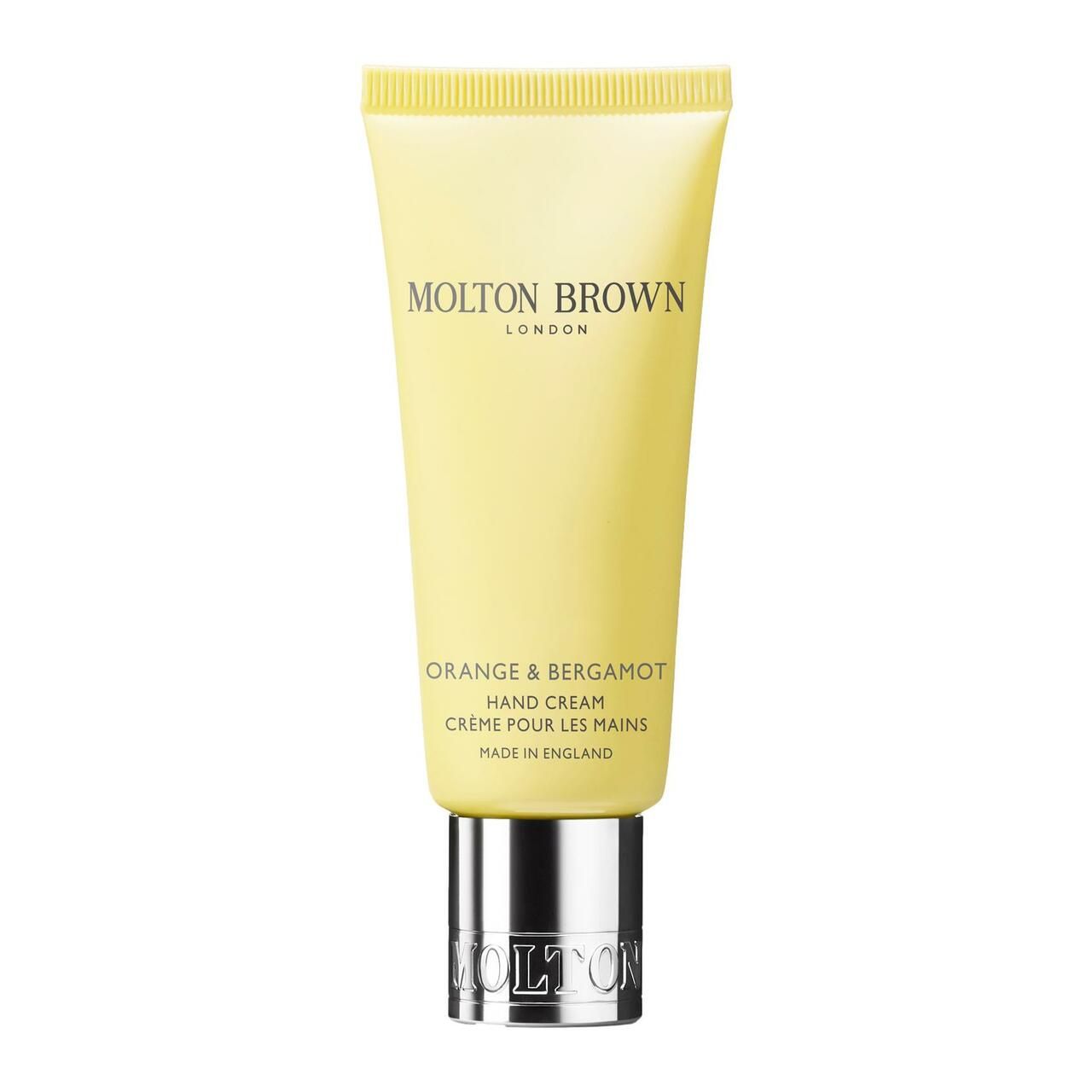 Gelbe Handcreme-Tube mit silberner Kappe. Aufschrift: Molton Brown London, Orange & Bergamot Hand Creme. Hergestellt in England.