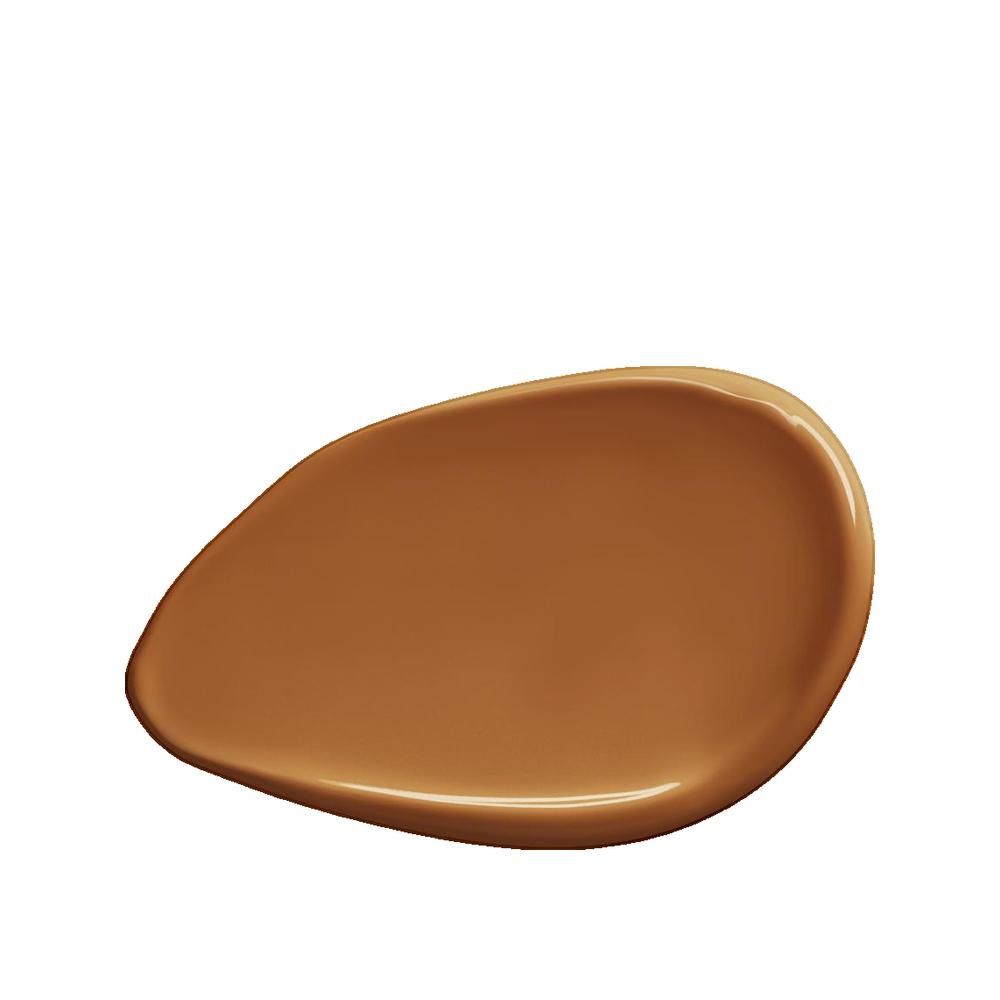 Hautfarbener Foundation-Fleck. Die Textur ist glatt und glänzend. Die Farbe ist ein warmer, dunkler Braunton.