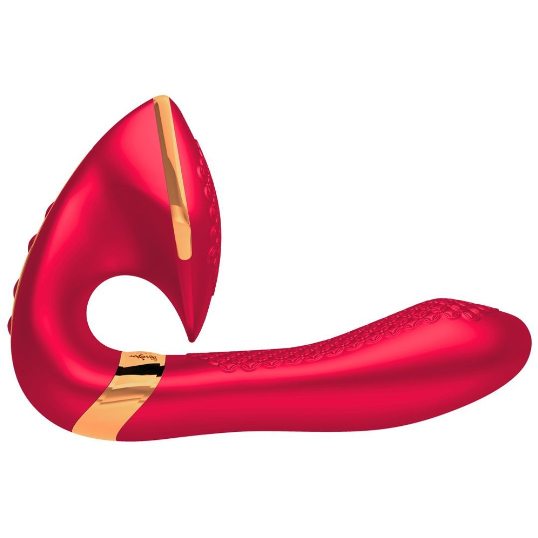 Roter Vibrator mit goldenen Akzenten. Geschwungene Form mit strukturiertem Schaft. Goldener Streifen mit Schriftzug.