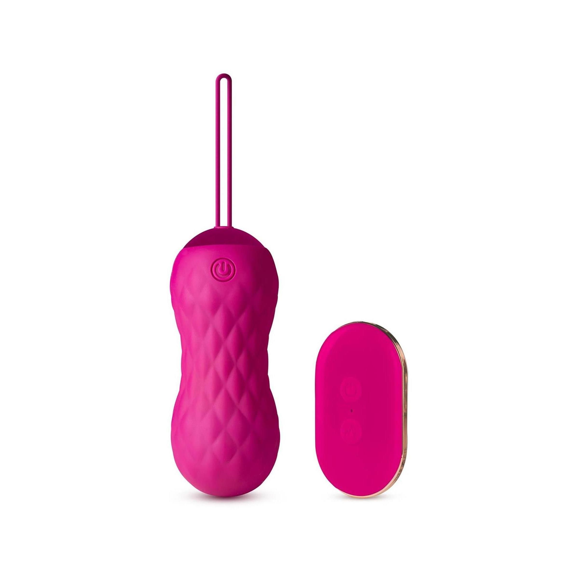 Rosa Vibrator mit Zugschlaufe und Fernbedienung. Der Vibrator hat ein Muster. Auf dem Vibrator ist ein Ein-/Ausschalter abgebildet.