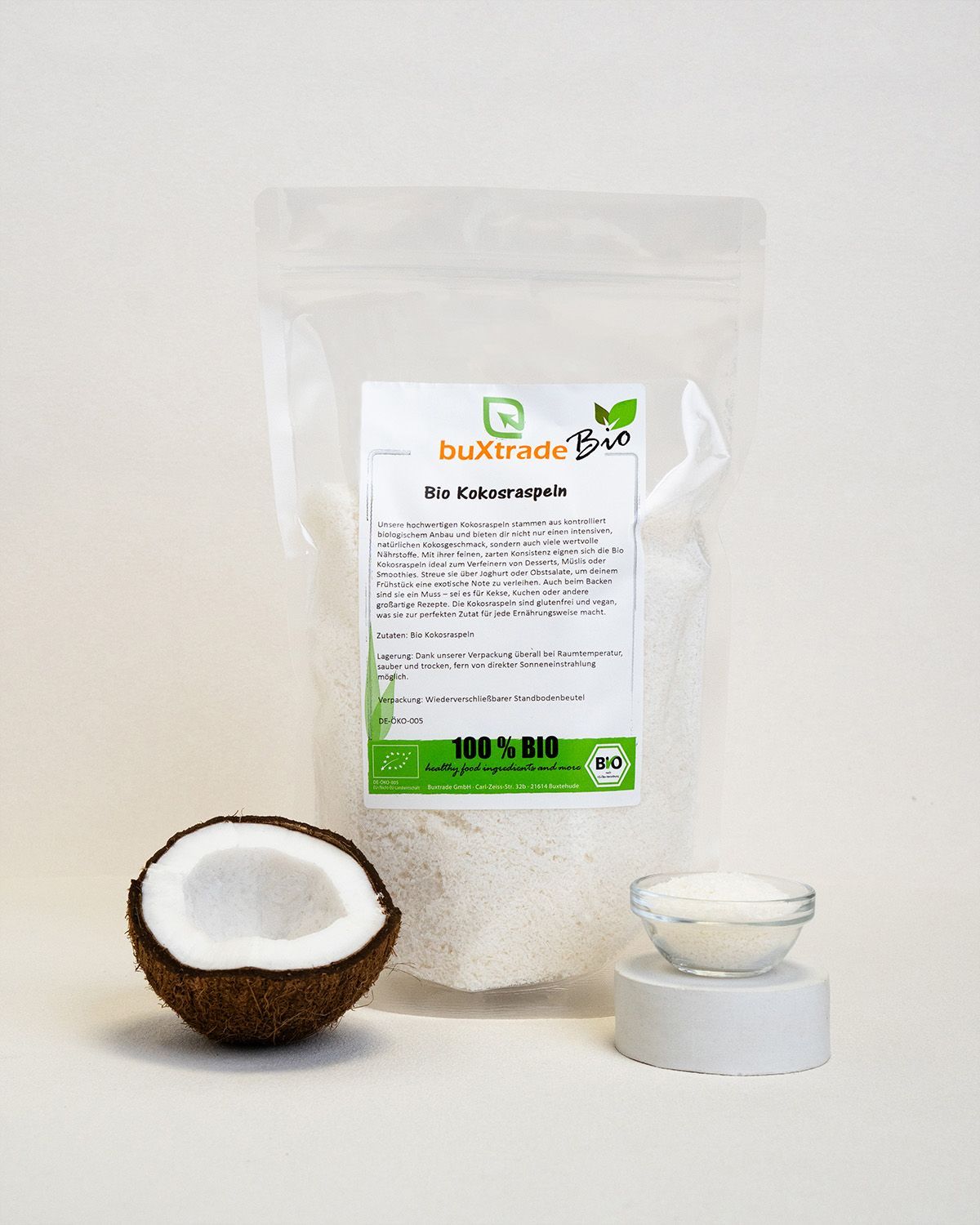 Verpackung buXtrade Bio Kokosraspeln, halbe Kokosnuss, Schale mit Raspeln. Bio-Siegel.