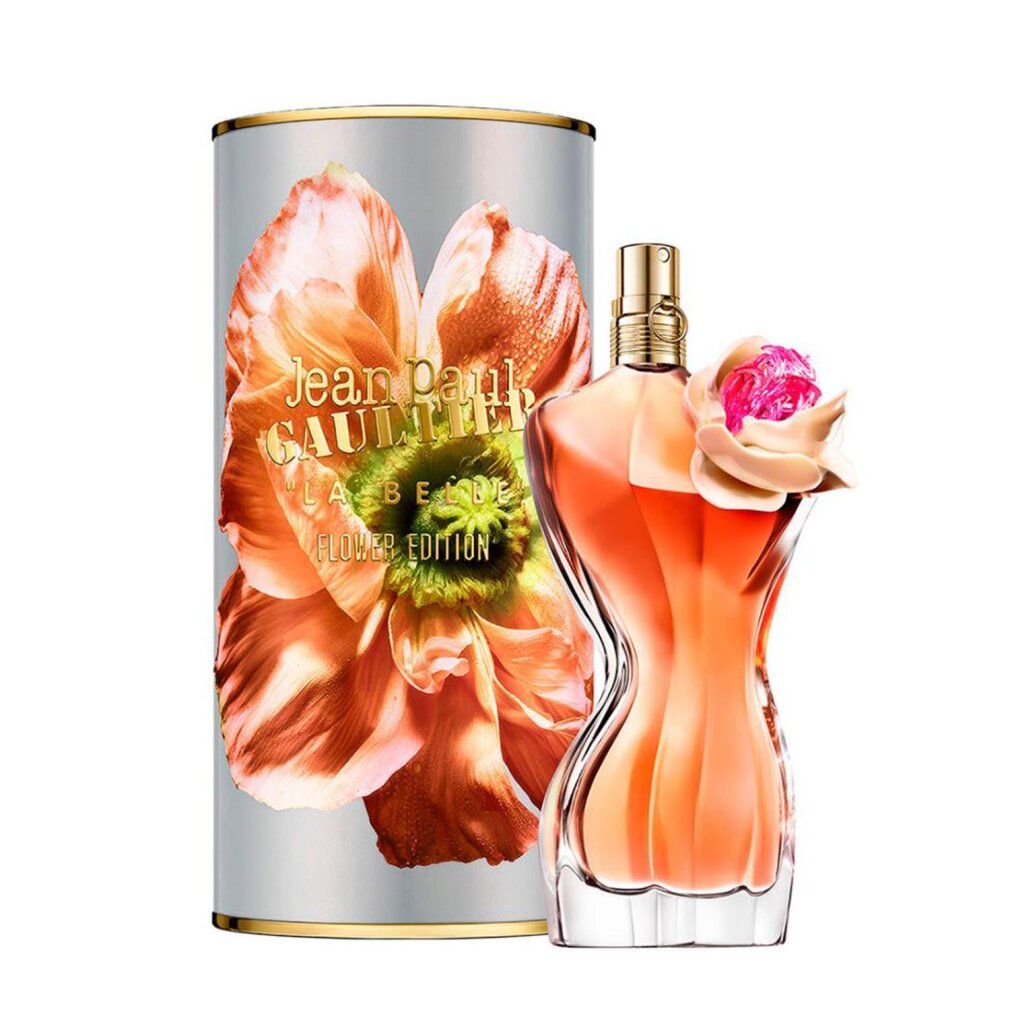 Parfümflakon in Torsoform mit Blüte. Zylindrische Verpackung mit Blumenmotiv und Schriftzug. Goldfarbener Verschluss.