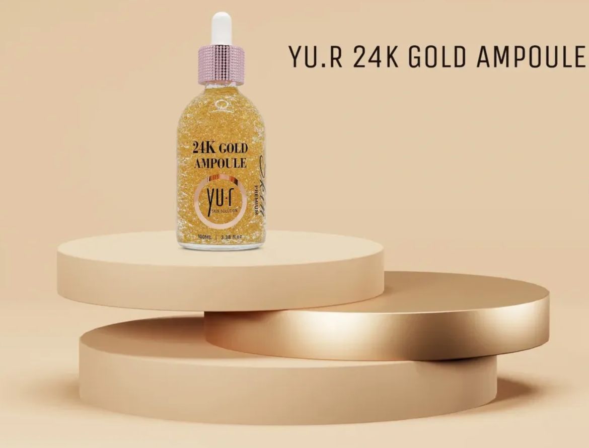 Serumflasche mit Goldflocken auf Podesten. Aufschrift: Yu.R 24K Gold Ampoule.