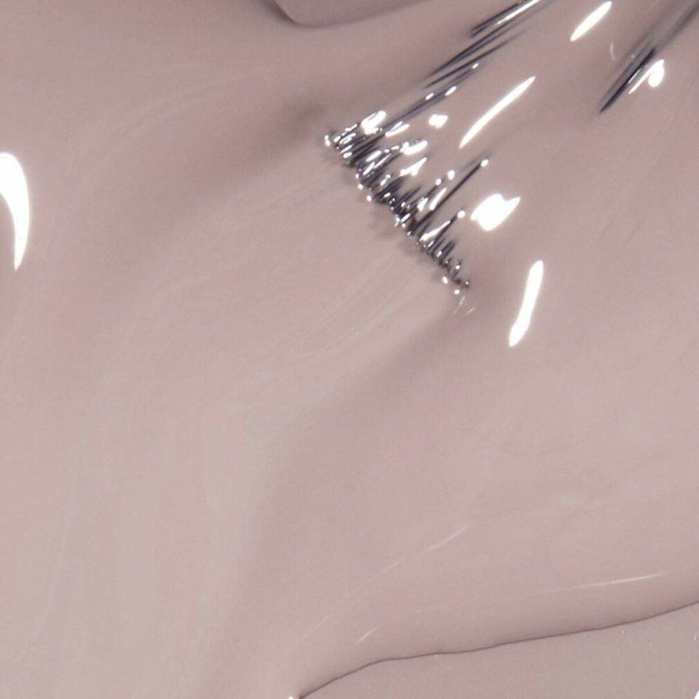 Nahaufnahme von Nagellack. Farbton: Beige. Pinsel mit Lack benetzt. Glänzende Oberfläche.