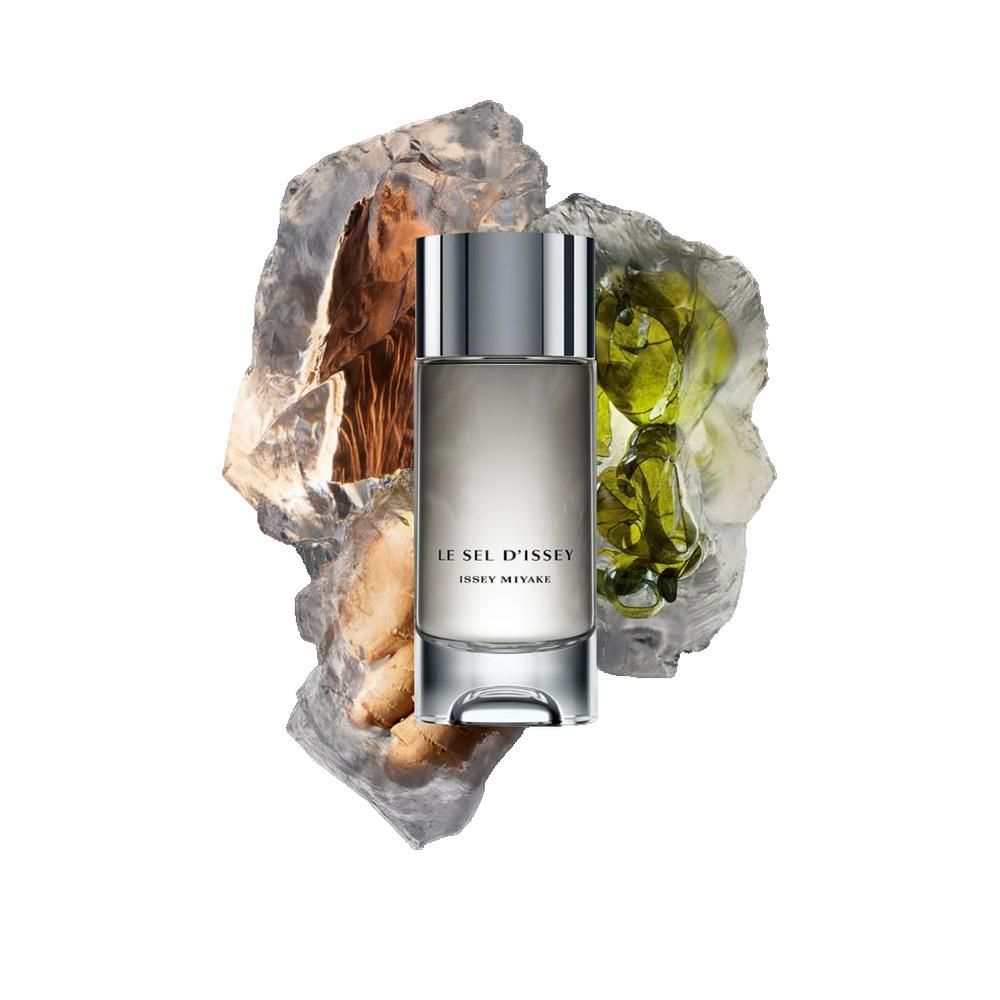 Flakon LE SEL D'ISSEY, ISSEY MIYAKE, auf Steinen und grünen Elementen. Silberner Verschluss, transparente Basis.