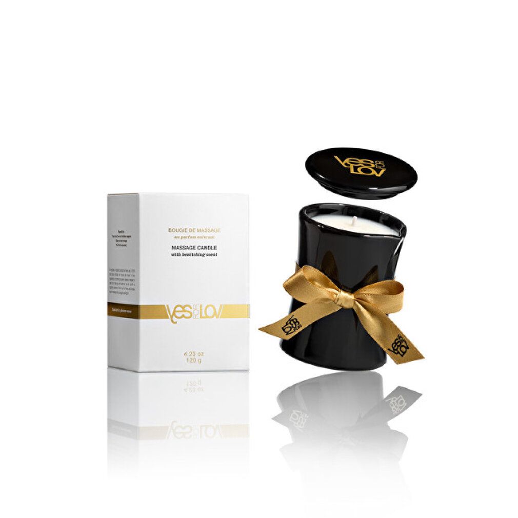 Schwarze Kerze mit goldener Schleife und Deckel. Weiße Verpackung mit Produktinformationen und Logo.