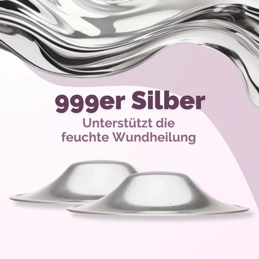 Zwei silberfarbene Brustwarzenhütchen. Text: 999 Silber. Unterstützt die feuchte Wundheilung.