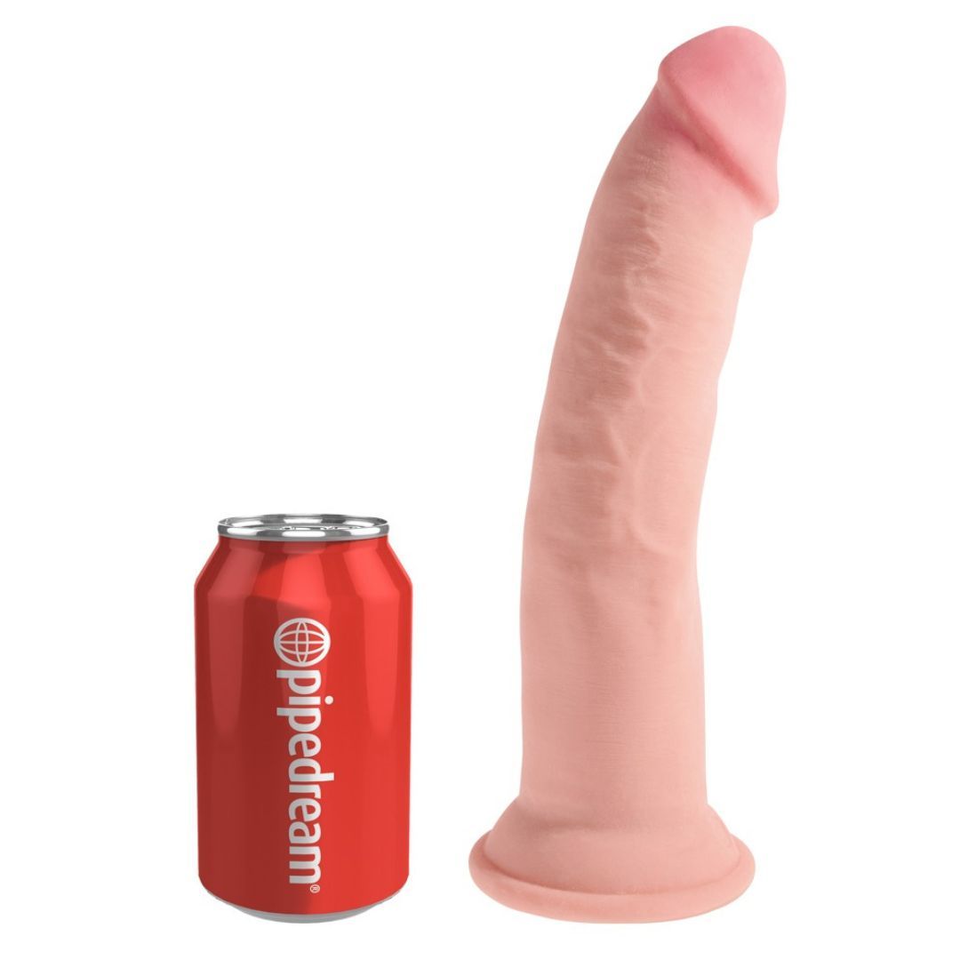 Rosa Dildo neben roter Getränkedose. Dildo mit leicht gebogener Form, breiter Basis und geriffelter Oberfläche.