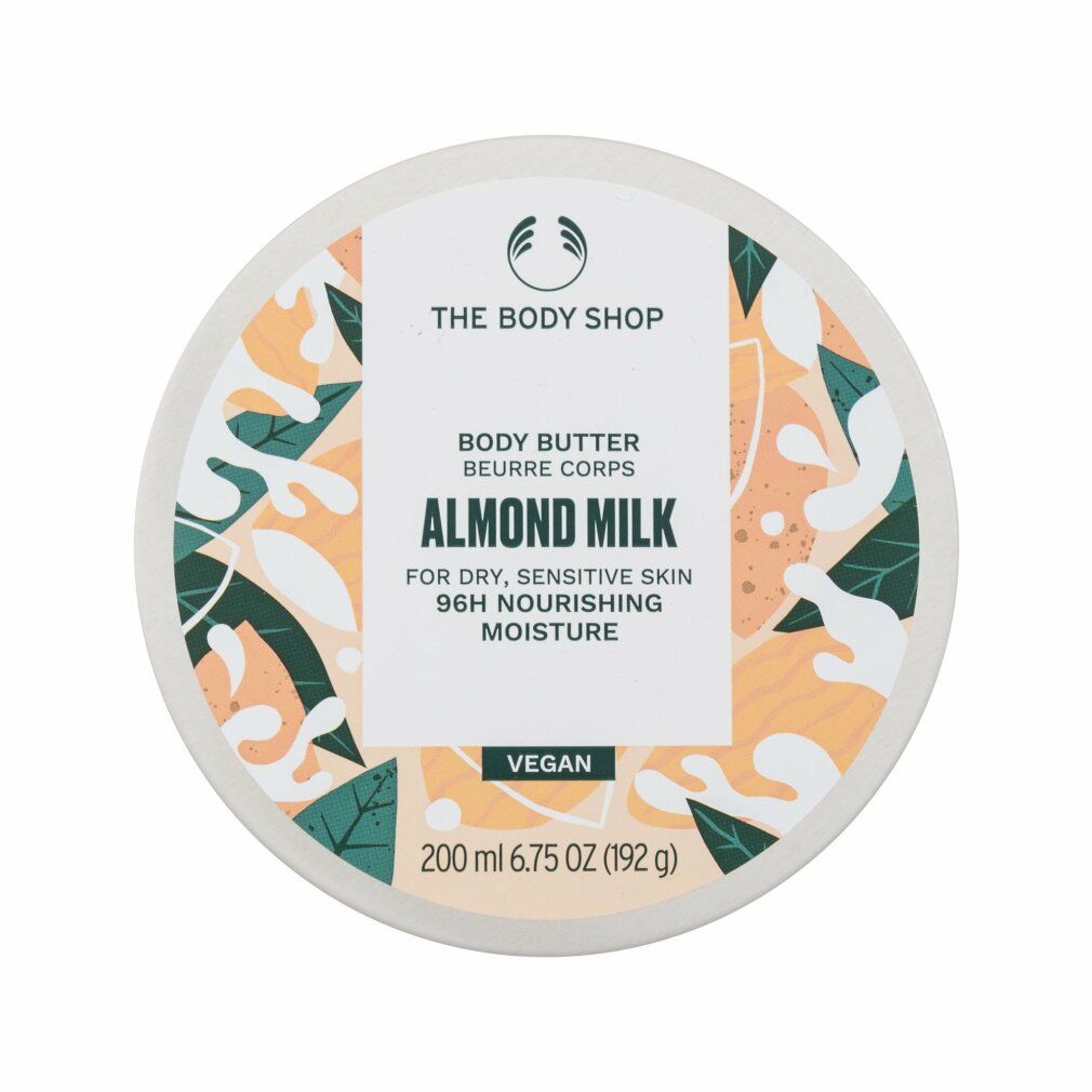 Runder Tiegel mit weißem Deckel. Logo: The Body Shop. Aufschrift: Body Butter Almond Milk. Vegan. 200 ml.