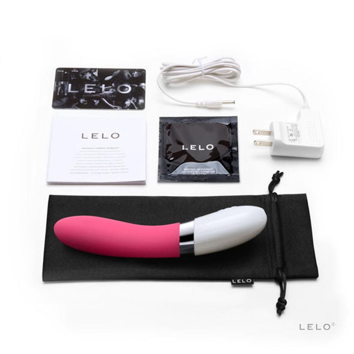 Vibrator mit rosa Spitze und weißem Kopf, Zubehör: Ladekabel, Beutel, Flyer, Feuchttücher. Marke: LELO.
