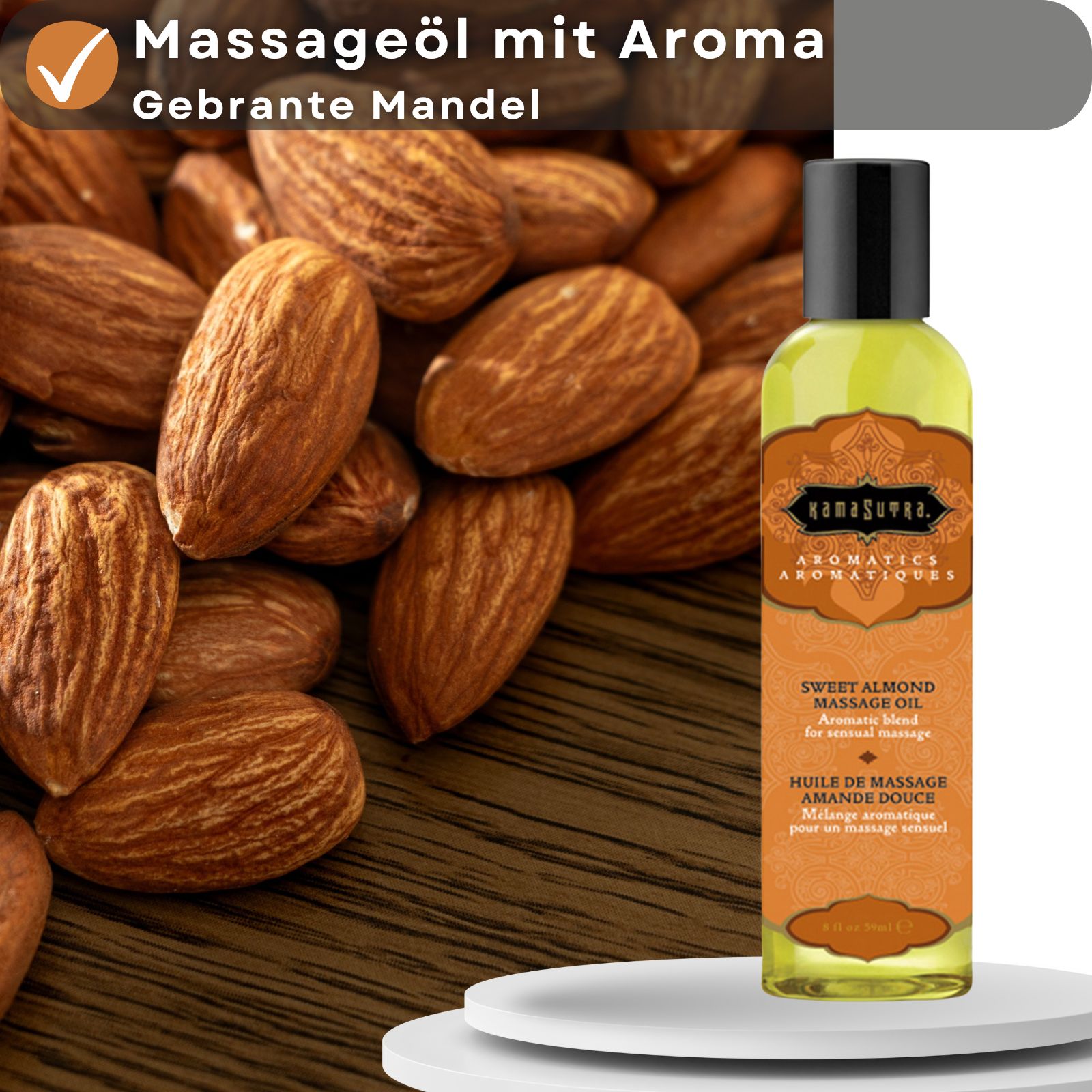 Massageöl-Flasche vor Mandeln. Textbox: Massageöl mit Aroma gebrannte Mandel.