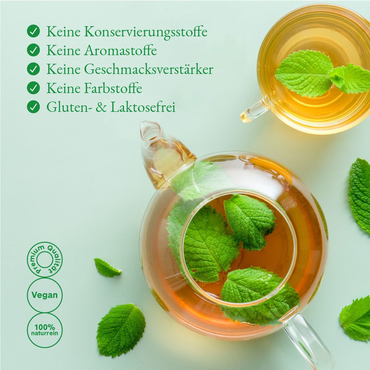 Glas-Teekanne mit Minze, daneben Tasse. Text: Keine Konservierungsstoffe, Aromastoffe, Geschmacksverstärker, Farbstoffe. Gluten- & laktosefrei.