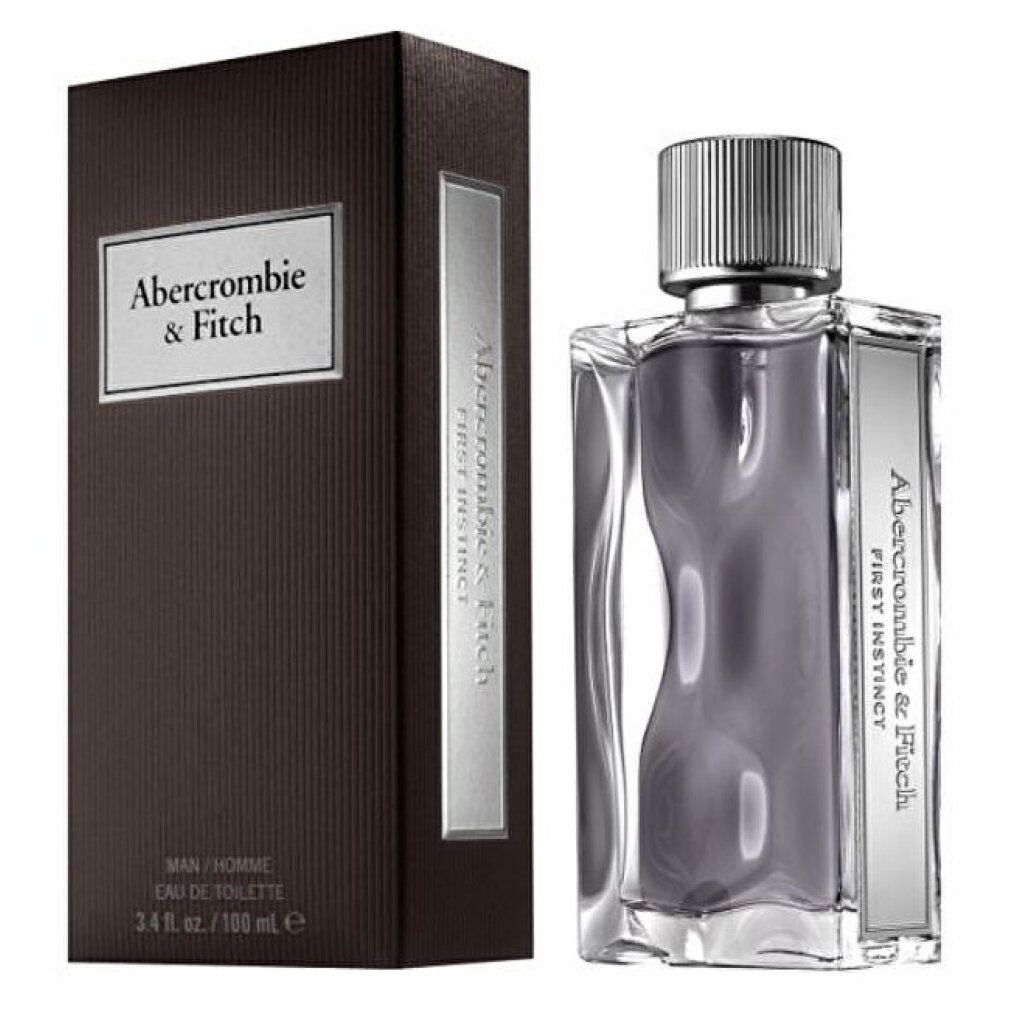 Parfümflakon und braune Schachtel. Flakon mit silbernem Verschluss. Aufschrift "Abercrombie & Fitch First Instinct". "Eau de Toilette".
