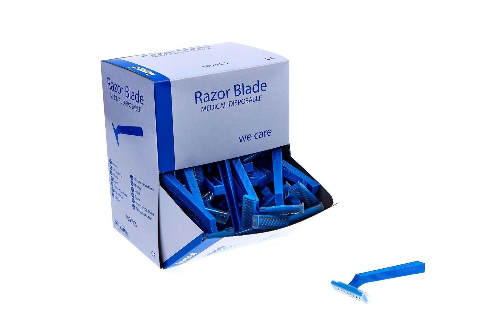 Karton mit blauen Einwegrasierern. Aufschrift "Razor Blade MEDICAL DISPOSABLE". Ein Rasierer liegt daneben.