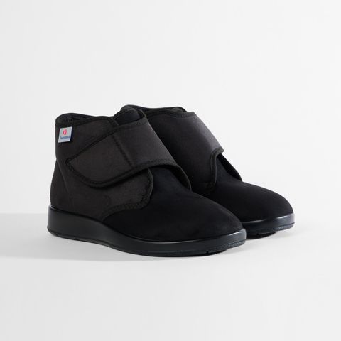 Schwarze Stiefeletten für Damen mit Klettverschluss, von der Seite.