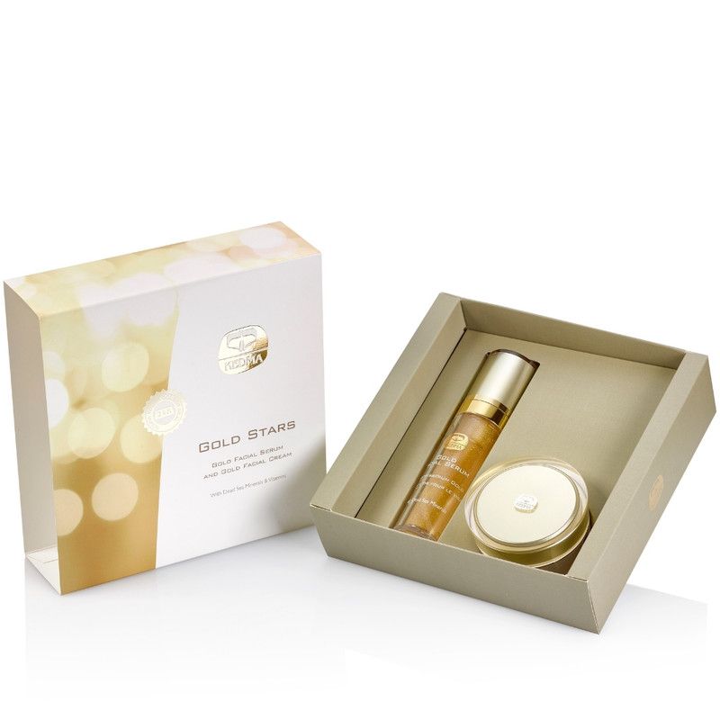 Geschenkbox mit Serum und Creme. Goldfarbene Flaschen und Tiegel in einer hellbraunen Schachtel. Aufschrift: Gold Stars.