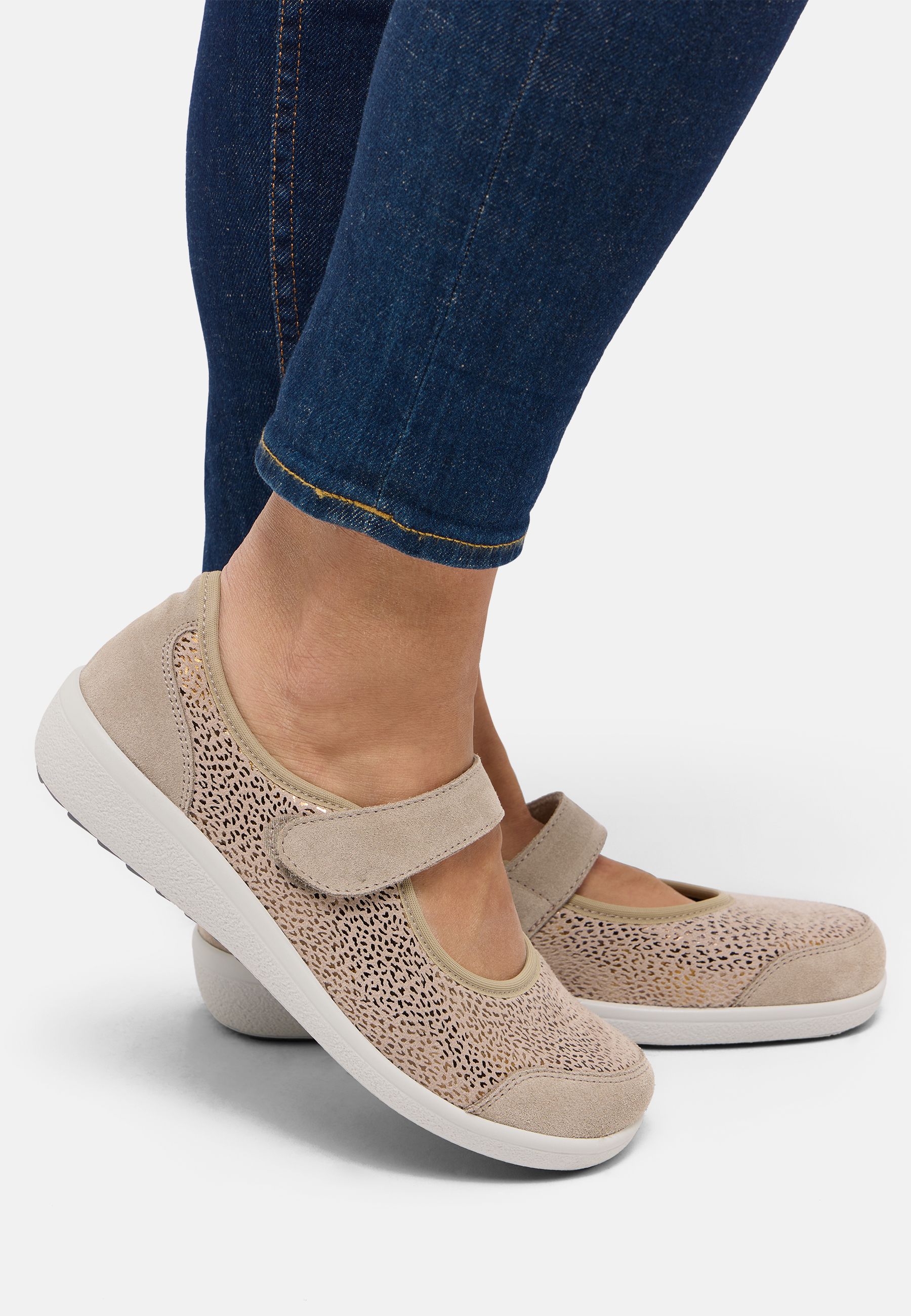 Beige Damenschuhe mit Klettverschluss und Lochmuster.