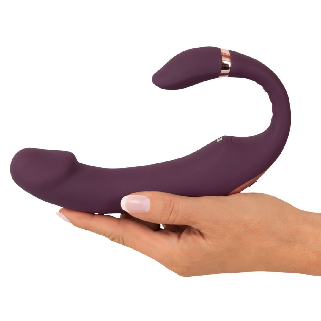 Lila Vibrator in Hand gehalten. Goldfarbene Akzente. 