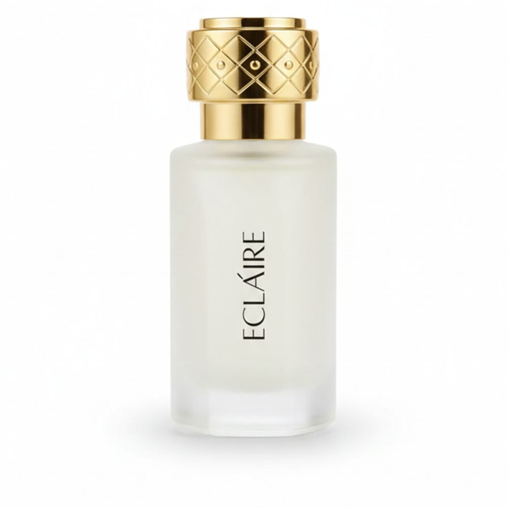 Klarer Glasflakon mit goldfarbenem Deckel. Aufschrift "ECLAIRE" in Schwarz. Flakon steht auf weißem Hintergrund.