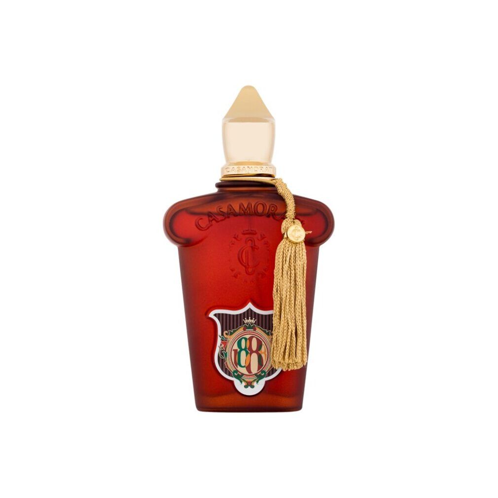 Rote Flasche mit goldener Kappe und Quaste, mit Logo und Schrift.