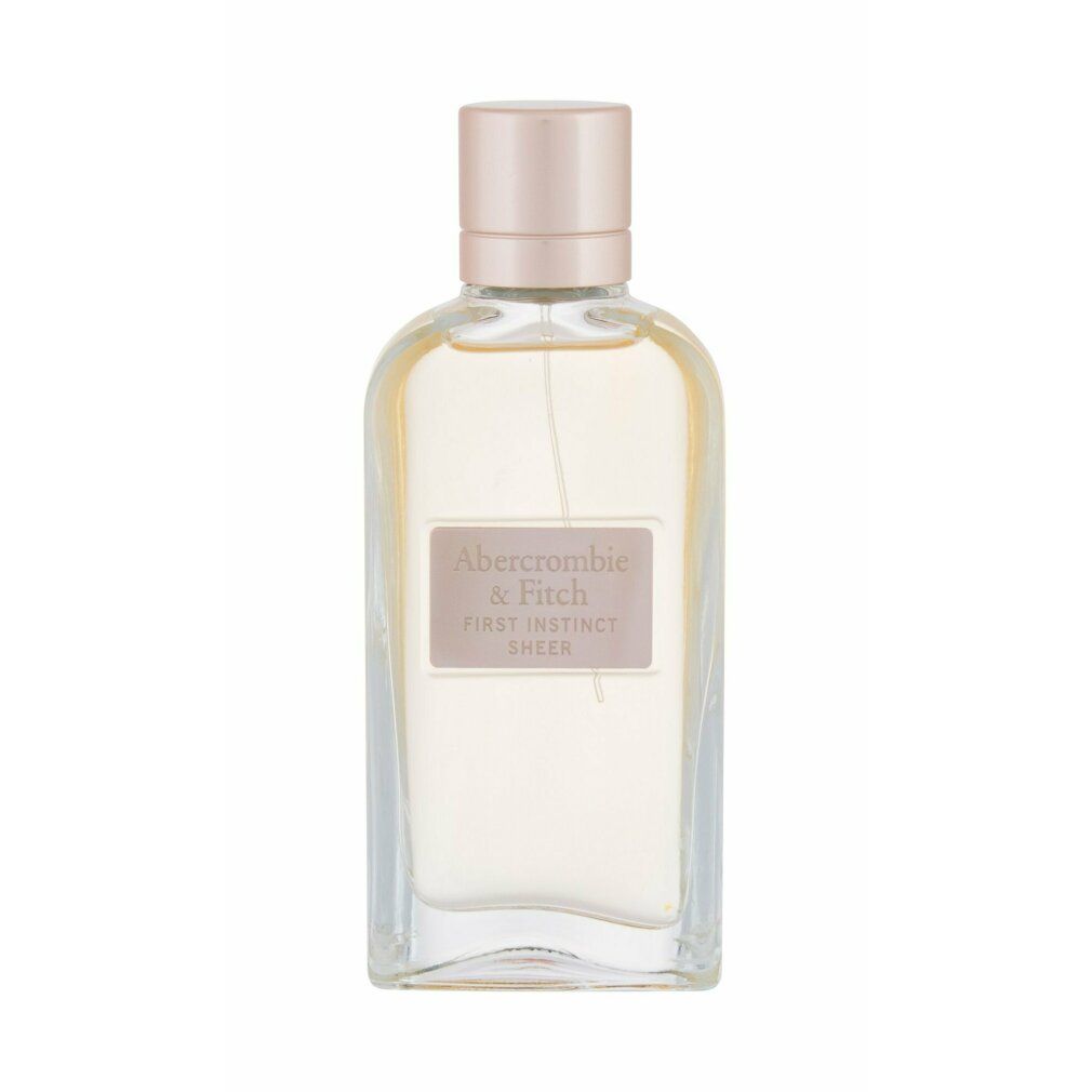 Transparente Glasflasche mit rosa Verschluss. Etikett mit Markenlogo und Produktname. Flüssigkeit sichtbar.