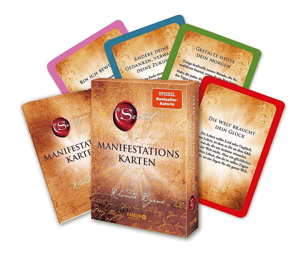 Kartenbox mit Karten. Box mit Titel "Manifestationskarten", rotem Siegel. Karten mit Text. Autor: Rhonda Byrne.