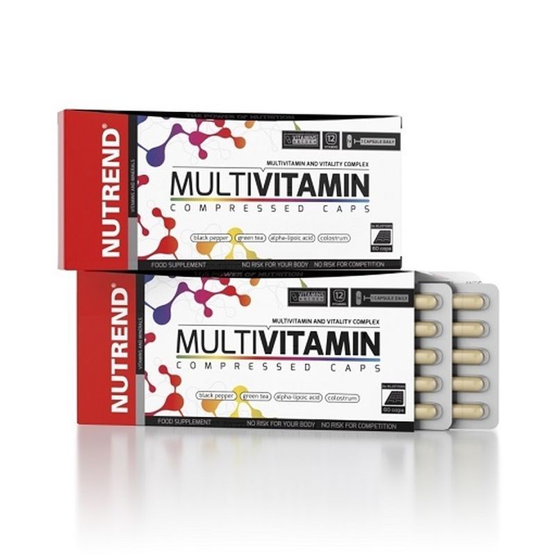 Zwei Schachteln mit "Multivitamin Compressed Caps" von Nutrend. Eine Packung ist geöffnet und zeigt Kapseln in Blistern.