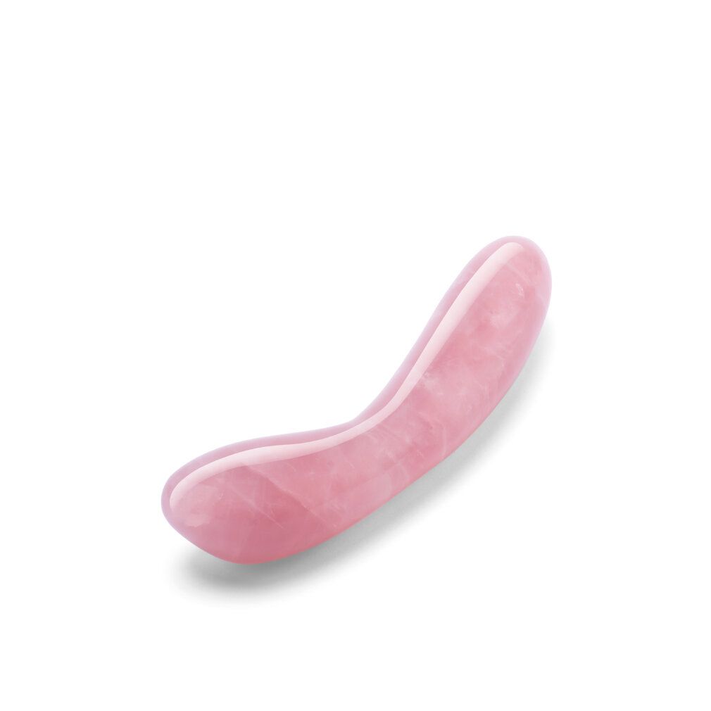 Rosa Kristall-G-Wand. Gebogene Form mit abgerundeten Enden. Glatte, polierte Oberfläche.