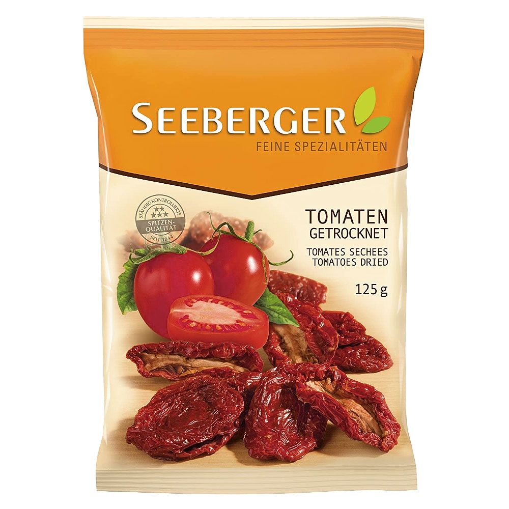 Verpackung getrockneter Tomaten. Aufdruck: Seeberger, Tomaten getrocknet, 125g. Abbildung von Tomaten und getrockneten Tomaten.