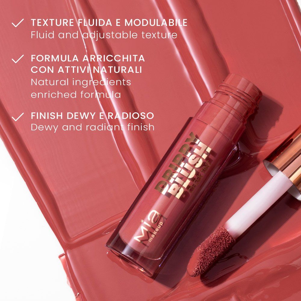 Mia Make-up Drippy Blush, in un contenitore con tappo color oro rosa. L'applicatore è visibile. Testo sul contenitore: Drippy Blush, Mia Make-up. Testo in italiano: Textura fluida e modulabile, Formula arricchita con attivi naturali, Finish dewy e radioso.
