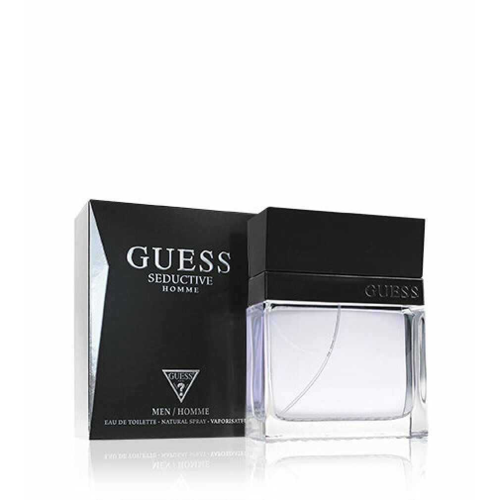 Guess Seductive Homme Eau de Toilette. Schwarzer Karton und Flakon. Flakon mit schwarzem Deckel. Text: GUESS, Seductive Homme, Eau de Toilette.