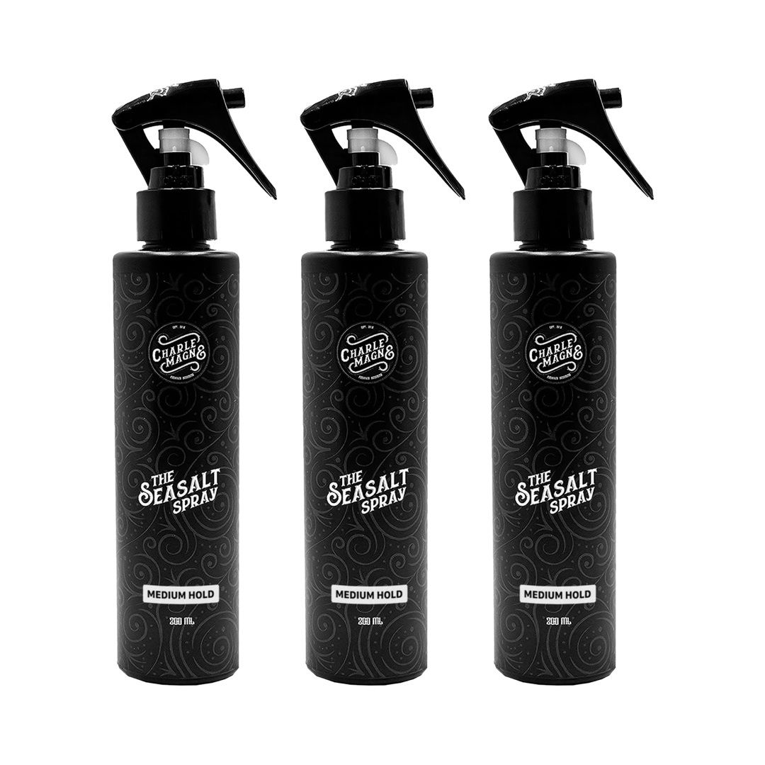 Drei schwarze Sprühflaschen mit "The Seasalt Spray" und "Medium Hold" Aufschrift.