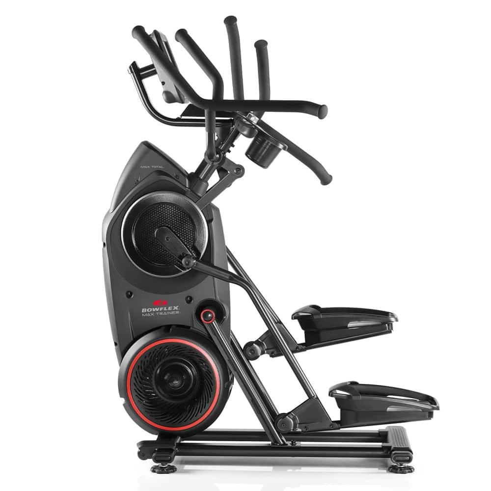 Schwarzer Bowflex Max Trainer Total. Seitliche Ansicht. Griffe, Pedale und ein Bedienfeld sind sichtbar. Roter Akzent am Schwungrad.