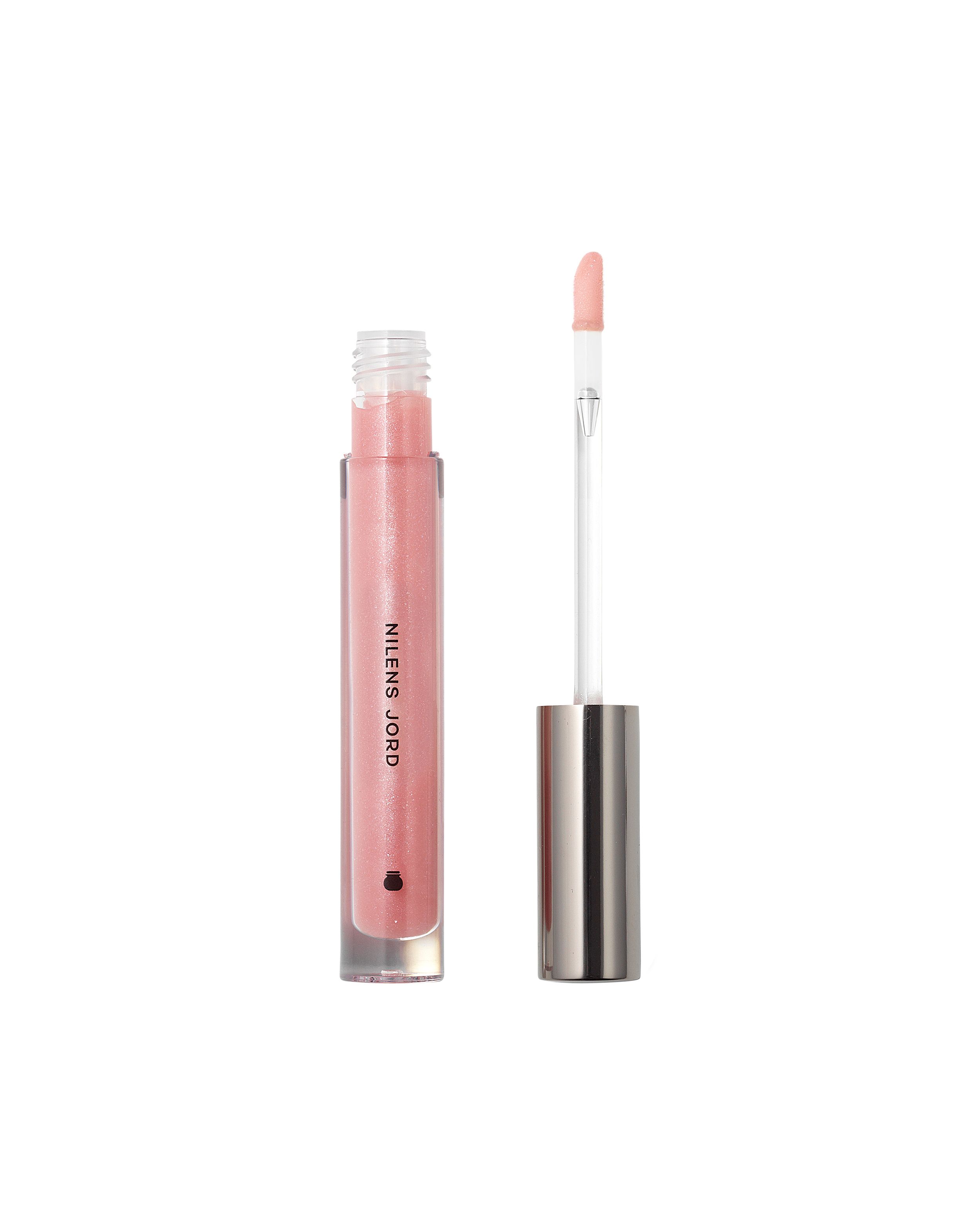 Nilens Jord Glossy Lips Lippenstift in transparenter Hülse mit silbernem Deckel und Applikator.