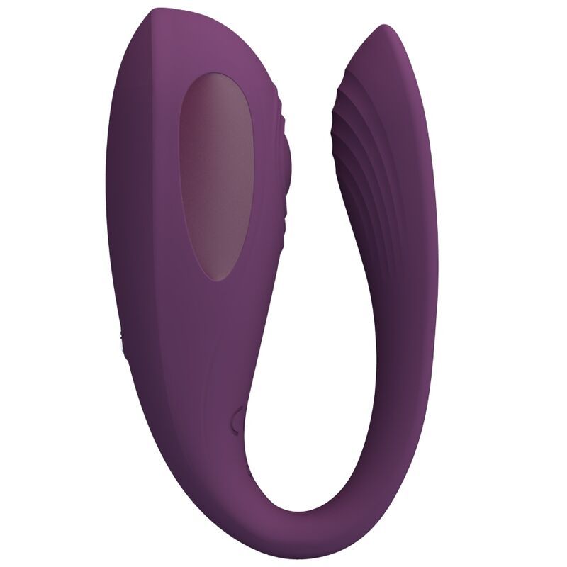 Lila Stimulator. U-förmig mit abgerundeten Enden. Eine Seite mit geriffelter Oberfläche. Zwei Knöpfe und eine ovale Aussparung.
