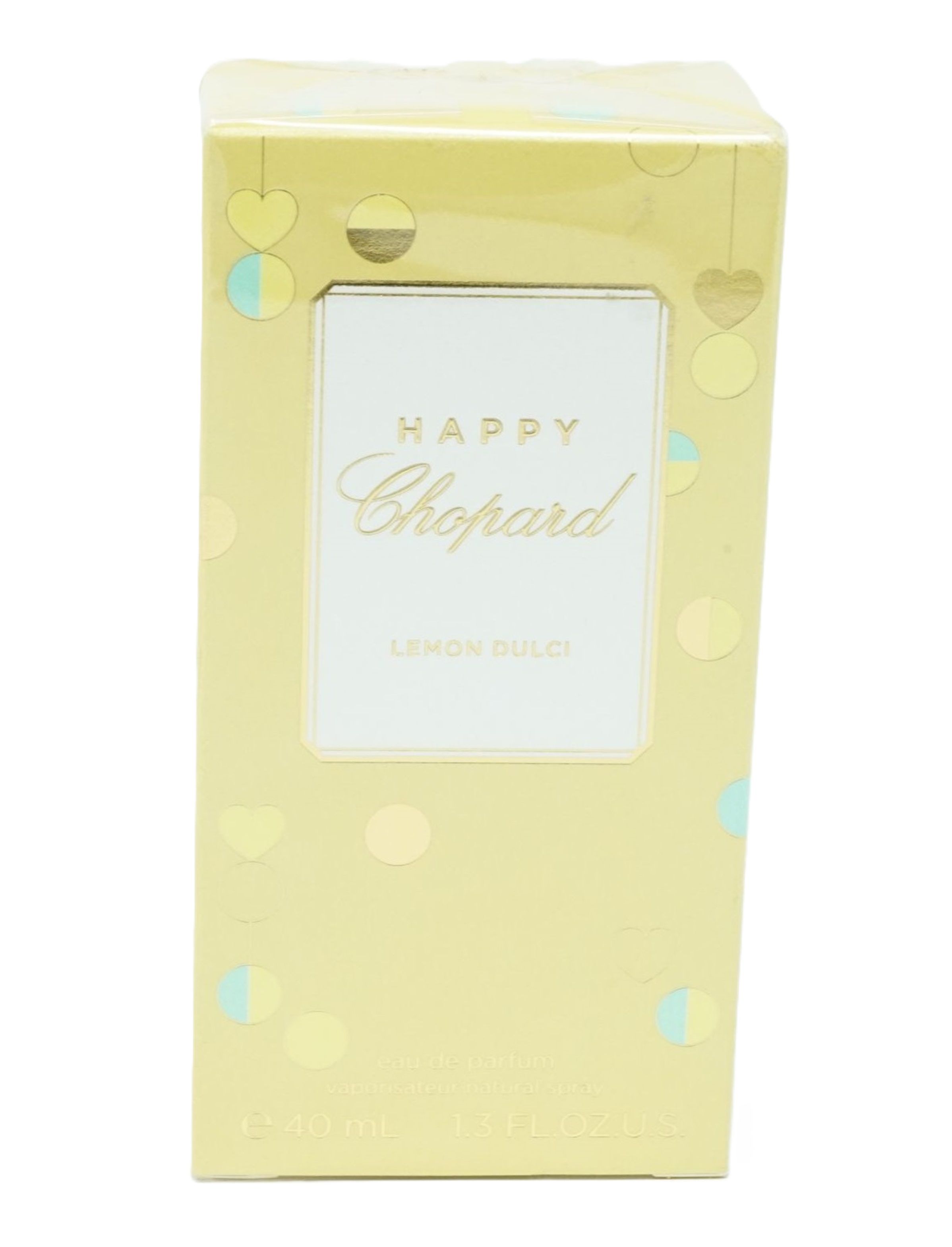 Gelbe Verpackung mit Aufschrift: Happy Chopard Lemon Dulci. Dekorative Elemente.