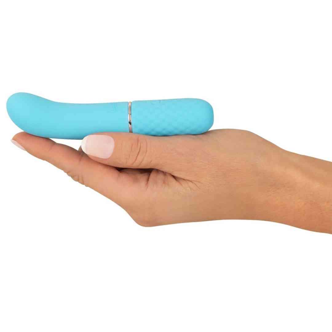 Türkisfarbener Vibrator in Hand gehalten. Gebogene Form, Rautenmuster, goldfarbener Ring.